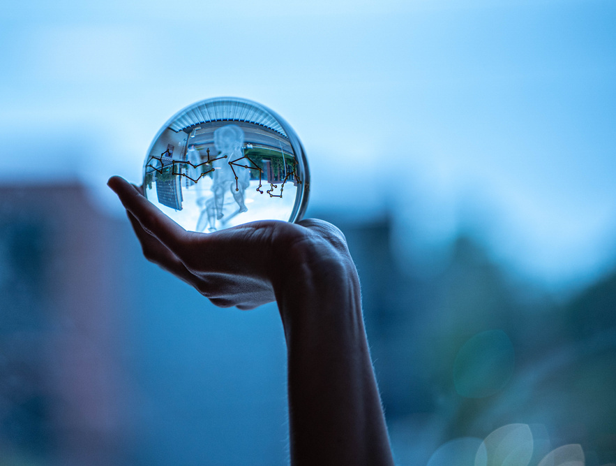 Hand holding a glass ball